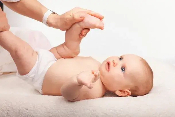 Chiropractor gently treating a happy infant
