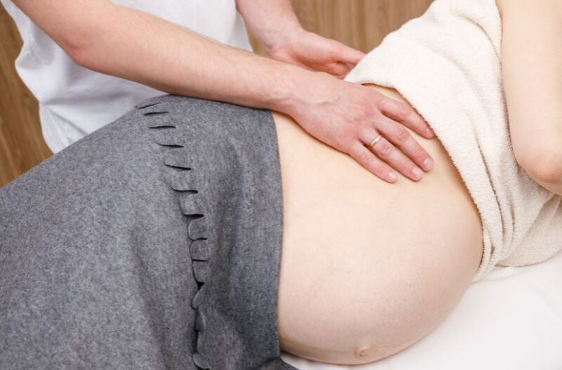 A pregnant woman takes chiropractic care